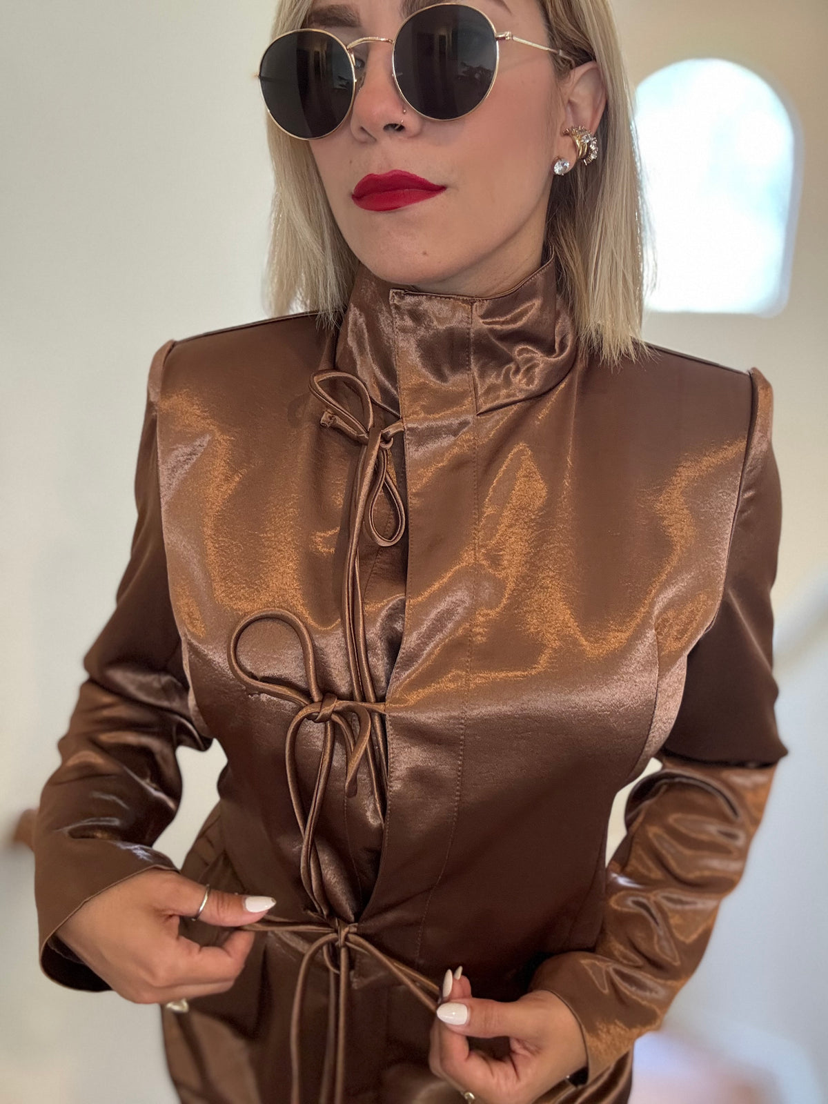 Bronze satin sleeved jumpsuit with high neck and multiple front tie strings