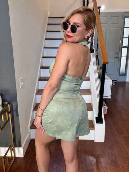 Light green halter romper with open back and V-neckline