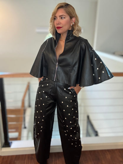 Black leather-style zip jacket with flared sleeves and studded wide-leg pants, full body