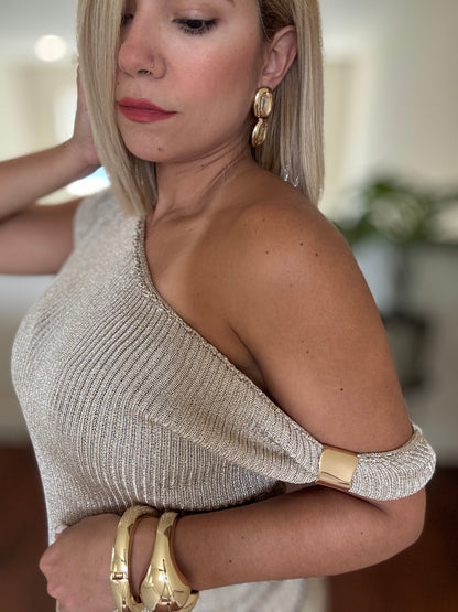 Estravaganza gold shimmer one-shoulder dress fabric texture with bracelet cuff