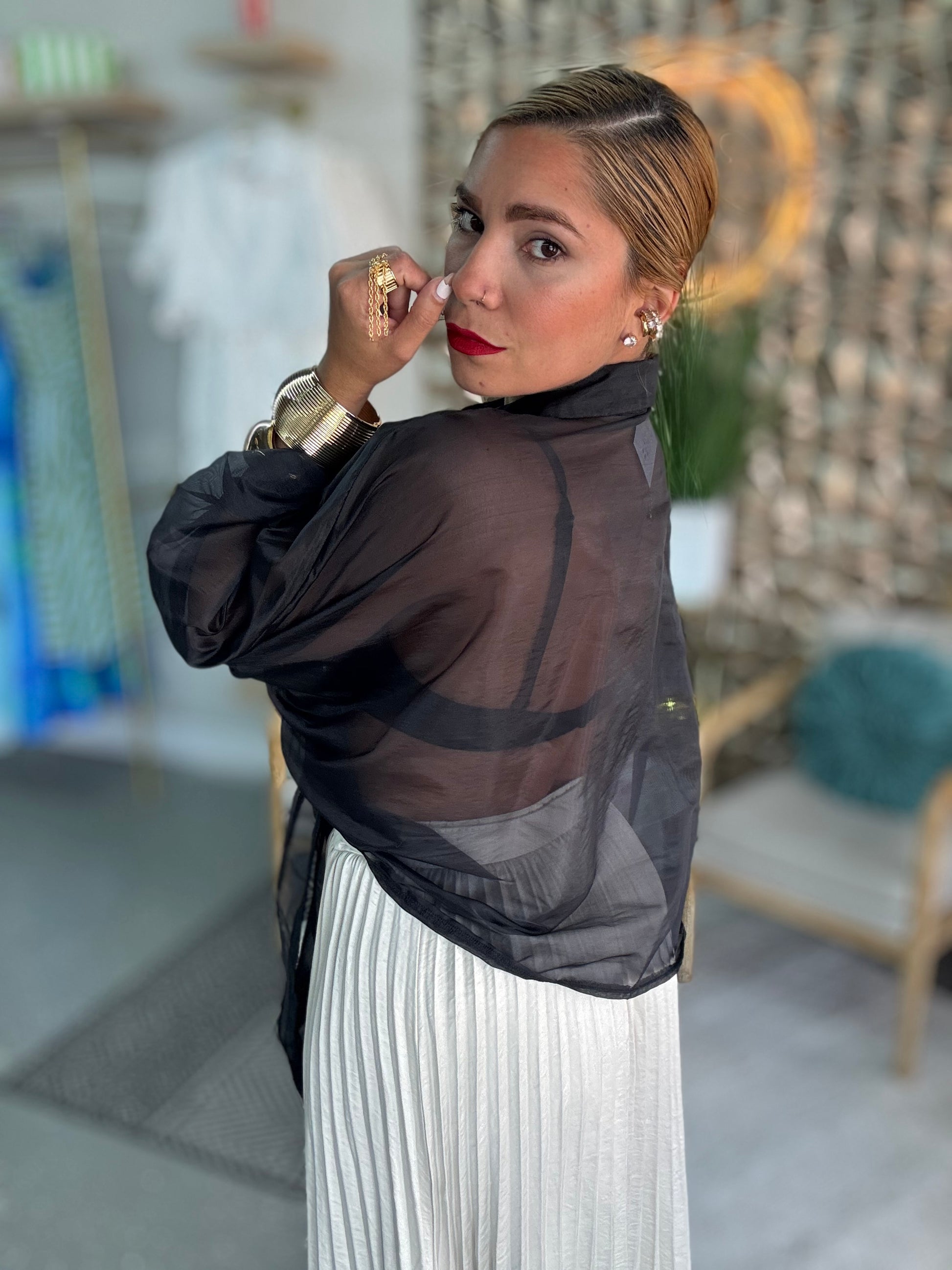 Black sheer blouse top with draped neckline and long sleeves