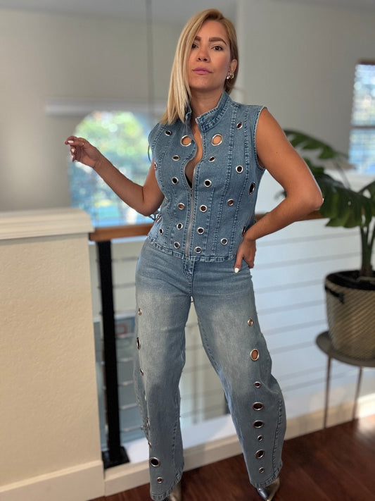 Light blue denim eyelet vest and jeans with circular grommet detailing.