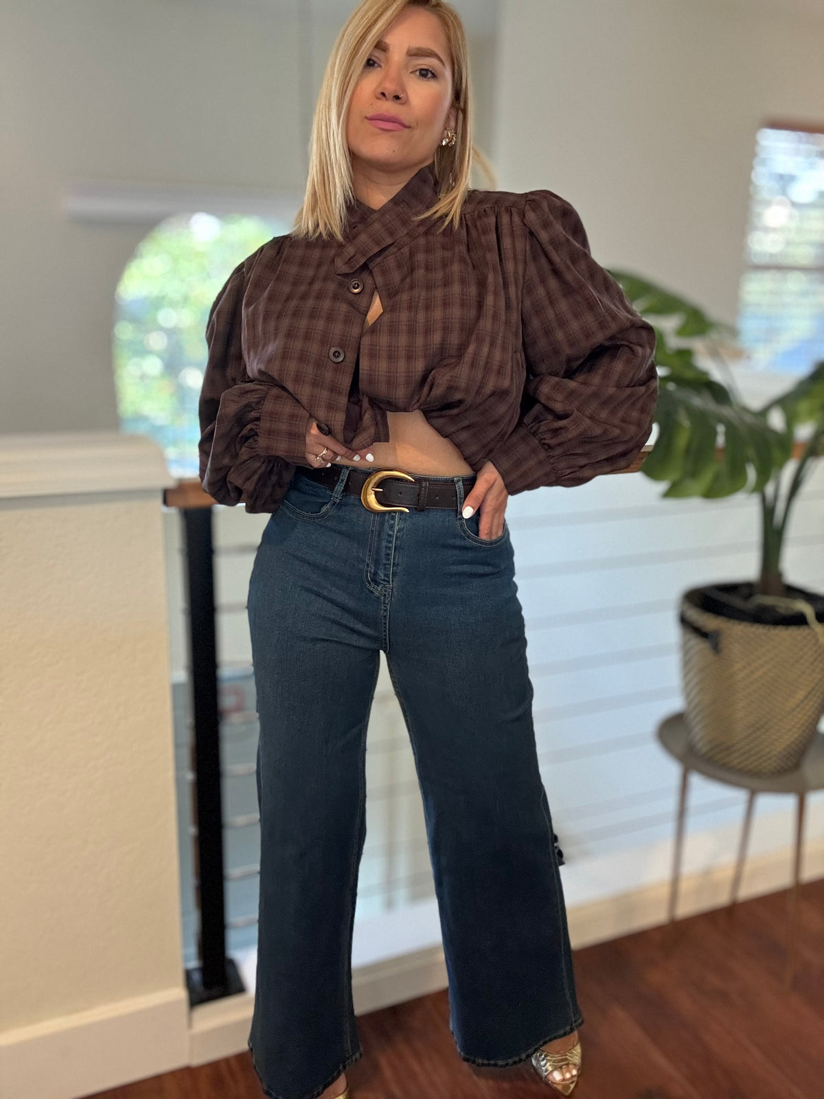 Dark blue jeans with belt loops, stitched pockets, and a zip fly front