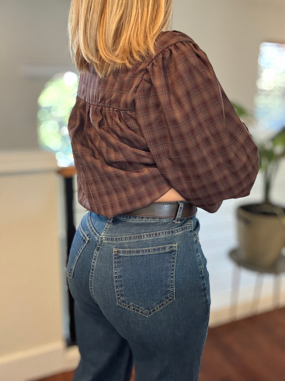 Back view of blue jeans with belt loops and a single back patch pocket