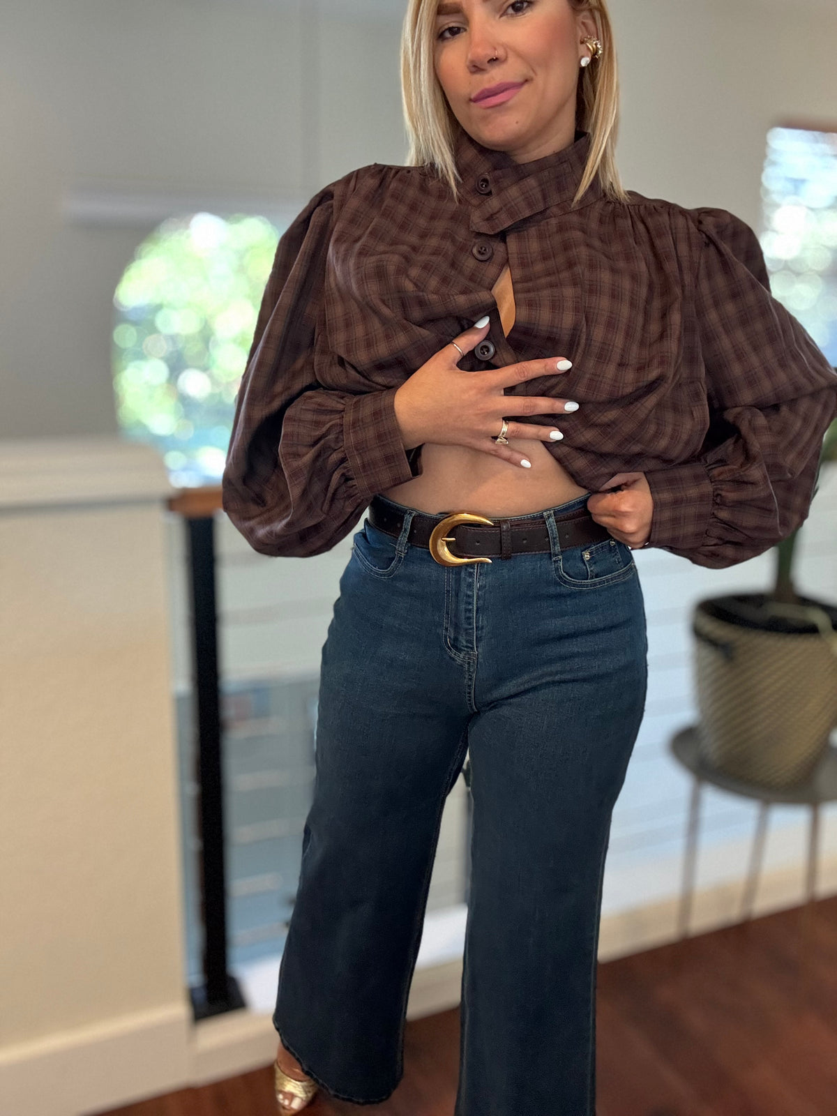 Blue denim jeans with belt loops, front pockets, and a slightly flared hem