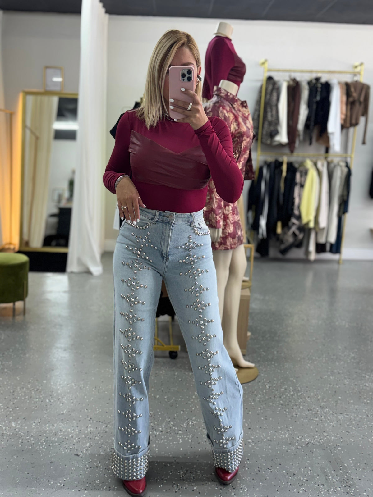 Light-wash studded jeans with silver-tone rhinestone-like dots on front and pockets